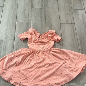 Adorable sprinkle dress with trim around the neck.